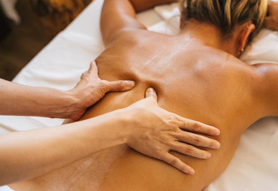 Massage thumbs applying pressure into mid-back area. massage.