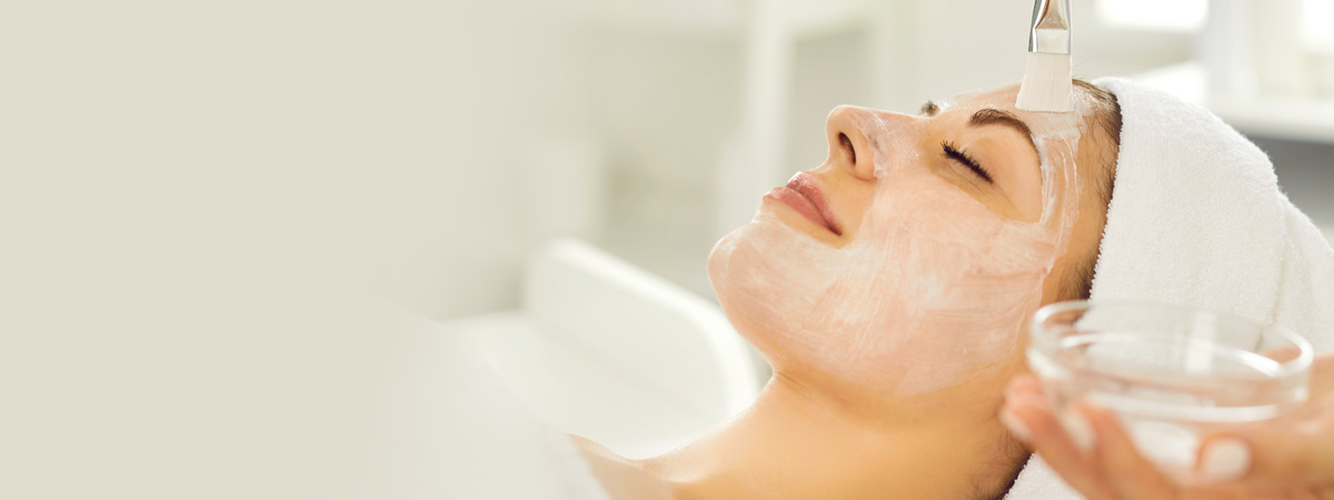 woman getting a facial mask applied