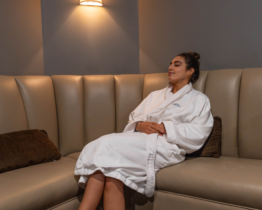 woman lounging in Relaxation Room in Oasis Westchester location